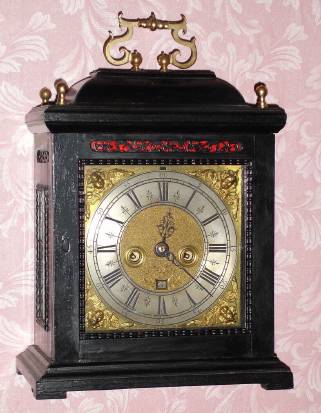 C.1690, English, Jonathan Loundes, (also Lowndes), Pall Mall, London, 8-day time and strike 2-fusee bracket clock. Nice brass dial with winged cherub spandrels, matte center w/ date aperture and ringed winding holes. — Antique Clocks Price Guide