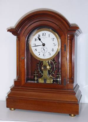 C.1906, [dated] English, Eureka Clock Co, Ltd, London, battery power mantel clock, in a quality mahogany case with reeded side columns w/ barss stop fluting, and featuring a large, seconds beating, vertical balance, serial No. 7421. — Antique Clocks Price Guide