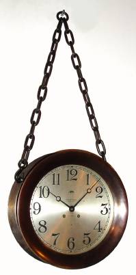 C.1926, Chelsea Clock Co., rare 10" CHELSEA CHAIN CLOCK, Ship's Bell, for Tiffany and Co., New York [on dial], hinged bezel, with factory bronze chains connected in center for wall hanging, the whole with original copper-bronze finish, serial No. 172729. — Antique Clocks Price Guide