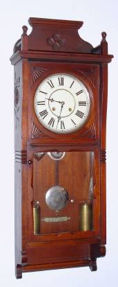 C.1883, Seth Thomas Clock Co., "FLORA" in mahogany, 8-day, 2-weight time and strike on cathedral gong, carved flowers on sides of the case. — Antique Clocks Price Guide