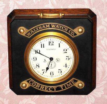 C.1930, Waltham Watch Co., "Waltham Chronometer" model, 8-day back wind with up/down indicator on the dial, mounted in a mahogany case with a black marble top with the company name and "Correct Time" in brass fastened on top. Counter top advertising piece for the retailer. — Antique Clocks Price Guide