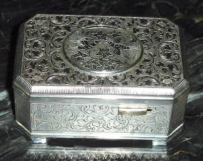 Late 20th Century, German, Singing Bird Box, silver plated over fancy embossed design that has the appearance of engraving. — Antique Clocks Price Guide