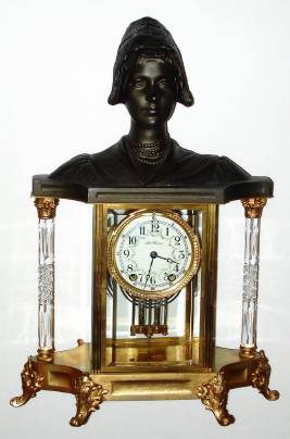 C.1905, Seth Thomas EMPIRE No. 32, fancy crystal regulator, with cut glass columns on each end and surmounted by a cast likeness of an Amish lady. — Antique Clocks Price Guide