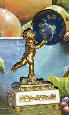 C.1890, French, Ormolu and Marble MINI figural timepiece, a cherub holding a globe aloft containing a very small cylinder movement. See clock next to life sized fruit bowl for comparison. — Antique Clocks Price Guide