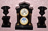 C.1890, French, Japy Freres, 8-day time and gong strike black marble, double dial calendar clock, with moon phase, 3 piece garniture set that was retailed by Tiffany and Co., New York.