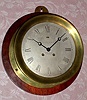 C.1912, Chelsea Clock Co., 8.5" CHELSEA, Ship's Bell, 8-day, retailed by W. E. Hadlock and Co., Boston, serial 84708, model 104 with hinged bezel, mounted to a 12.5" dark pine board.