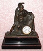 C.1900, French, Marti and Cie, 8-day time and bell strike bronze and marble figural mantel clock. Translation of the Greek inscription on the scroll the warrior is holding reads: "Having given up your weapons, take up other things", idiomatic translation: "Turn from War to Learning". 