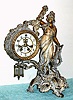 C.1913, William L. Gilbert Clock Co., "Beatrice", 8-day time/strike figural mantel clock, exposed escapement and pendulum.