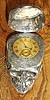 C.1910, an English "Skull Timepiece", silver and bone, the latch hallmarked, with a C.1840 English fusee, lever watch movement, key wound, with gilt dial. 