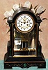 C.1895, French, Marti and Cie, 8-day time and bell strike, black marble clock, with malachite inserts retailed by D. H. Buell and Co., Hartford (on dial, with open escapement), and with 2 vial compensating pendulum. 