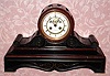 C.1900, French, 8-day time/strike black and red marble tambour clock retailed by Bigelow, Kennard and Co., Boston. 