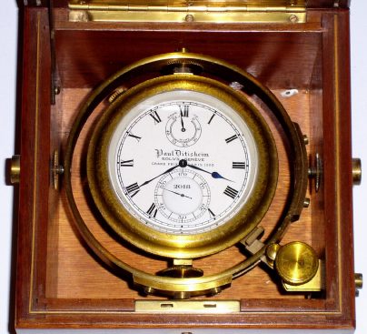 C.1910, Swiss, Paul Ditisheim, Chronometer Watch, or as included literature calls it Chronometer, Petit Format, 21j, key wound, going barrel with enclosed compensated balance, 2-day, in a full 3-piece mahogany case with brass corners. — Antique Clocks Price Guide