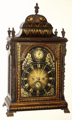C.1775, English, for the American market, a Georgian large twin fusee, crown verge, bracket clock, with gold stenciling over ebonized finish, and a matching black/gold painted dial, with cast flame finials and caryatids at the corners. — Antique Clocks Price Guide