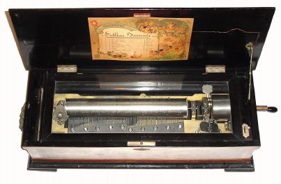 C.1890, Mermod Freres, St. Croix, Switzerland, ten tune music box with original tune sheet; longer running spring with Jacot Safety Check and tune indicator to the left. 14.5" wide cylinder, double comb, Sublime Harmony. Key wound from the right side of the box. — Antique Clocks Price Guide