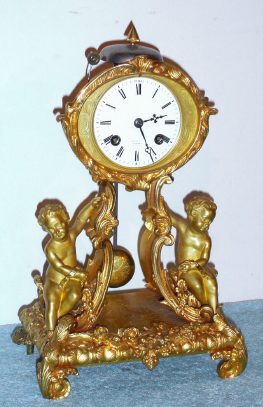 C.1850, French, Japy Farres, Paris: French Ormolu miniature shelf clock with cherubs and 8-day time and strike movement, the dial set into an oval easel. — Antique Clocks Price Guide