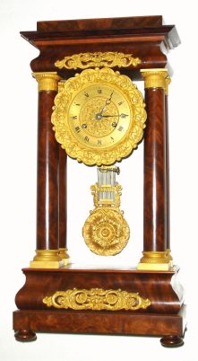C.1850, French, Empire Style 4-Column portico clock, in crotch mahogany with fire gilt accents, the movement with no marks and with venier beat adjustment. — Antique Clocks Price Guide