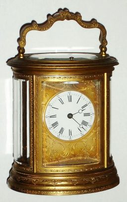 C.1880, French, Brass Cased Carriage Clock, Larger Oval, fully engraved including handle and dial mask, time strike and repeat, 8-day. — Antique Clocks Price Guide