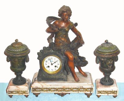 C.1900, French, Samuel Marti, Paris, 3-Piece Mantle Garniture, L' Histoire, a young girl with pen in her right hand, with her diary open, roses in her lap. Urns and figure of patinated white metal, with ormolu acanthus garlands spread across the marble bases. — Antique Clocks Price Guide