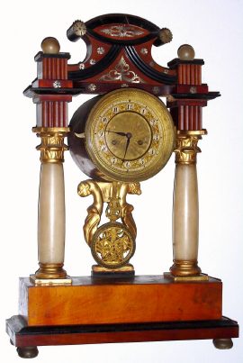 C.1830, Austrian portico shelf clock. Mahogany with silver-metal inlay, ebony trim and alabaster columns with 1-2 day time and strike silk-suspension movement.. — Antique Clocks Price Guide