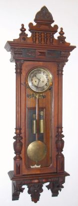 C.1880, German, Gustav Becker, 2-Wt, Vienna Regulator, in a carved Alt Deutsch case, the later movement on a wooden slide mounting to the sides of the case, and with old top. — Antique Clocks Price Guide