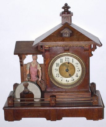 C.1910, German, Blacksmith Novelty automaton, RINGS BELL when it strikes, back wind lever movt, 30-hour, carved and painted wooden man lifts is hammer high above the anvil to ring the hour. — Antique Clocks Price Guide