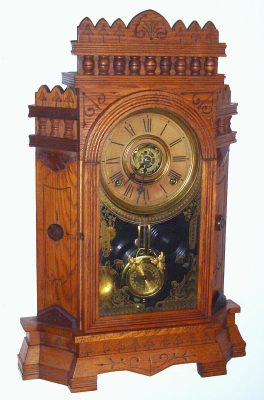 C.1885, Wm. L. Gilbert, ALTAI,  pressed oak parlor clock with canted sides and fancy top, 8-day time, strike on cathedral gong, and with alarm. — Antique Clocks Price Guide