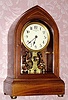C.1910, English, EUREKA CLOCK CO, Ltd, London, battery powered mantel clock in mahogany, with satinwood line inlay, serial No. 9078. 