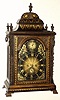 C.1775, English, for the American market, a Georgian large twin fusee, crown verge, bracket clock, with gold stenciling over ebonized finish, and a matching black/gold painted dial, with cast flame finials and caryatids at the corners. 