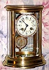C.1900, French, Brass Cased, OVAL CRYSTAL regulator, 8-day time and gong strike, with a fancy brilliant studded portrait pendulum and matching bezel, the dial with floral polychrome decorations. 