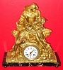 C.1870, French, Ormolu Figural Clock,  a gentleman in 16th century dress, holding his sleeping sweetheart in his lap, her breast exposed. The well made French striking movement of week duration. 