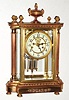 C.1908, Waterbury Clock Co., SEVRES, 4-glass crystal regulator, flanked by 2 free standing columns and surmounted my a decorative urn, also with open escapement on the porcelain dial. 