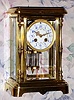 C.1900, French, Japy Freres, Crystal Regulator, in a brass case with full standing columns at the front corners; a cream colored dial with polychrome floral decorations and a 2-vial compensating pendulum. 