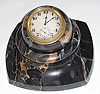 C.1930, Swiss, Gubelin, Gray marble desk clock, a jeweled rim wind clock, set into a variegated marble ball, which in turn sets into a matching recess in the marble base, so that it can be swiveled to any angle for viewing. Pull rim up for setting hands. 