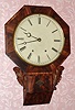 C.1850, Chauncey Jerome, New Haven, Conn, octagonal wall clock with carved side pieces and 8-day time and strike movement with attached fusees. 