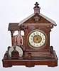 C.1910, German, Blacksmith Novelty automaton, RINGS BELL when it strikes, back wind lever movt, 30-hour, carved and painted wooden man lifts is hammer high above the anvil to ring the hour. 