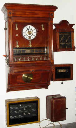 [5 Pieces] C.1890, Seth Thomas (Mov't) Burglar Alarm Instrument, Style C, mahogany cased wall clock with 8 station servant call system, along with 4 auxiliary / remote boxes, which appear to have been added to the system. — Antique Clocks Price Guide