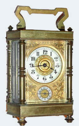 C.1900, French, Brass Cased Carriage Clock, time and alarm, in an unusual hexagonal case with 6 vertical columns and 7 total panes of beveled glass, with a gilt floral dial mask with porcelain chapter and alarm rings. — Antique Clocks Price Guide