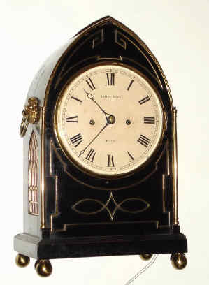 C.1830, English, Bell Strike Bracket clock. 2-fusee, in a Regency lancet top ebonized case with brass inlay, and with round painted dial bearing the name Jas. Evill, Bath. — Antique Clocks Price Guide