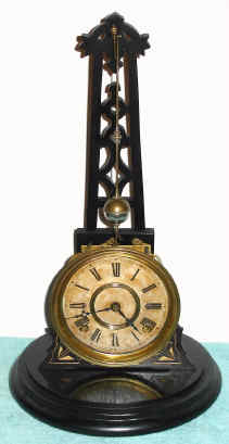 C.1882, F. Kroeber Clock Co., New York, "Noiseless Rotary No. 1", time and strike novelty clock with rotary pendulum that travels in a cone shaped path, in oil derrick form with glass dome, 8-day, strike. — Antique Clocks Price Guide