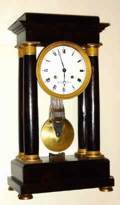 C.1840, French, Horiot, a' Paris, 4-Column, Empire style mantel clock, large, 8-day, bell strike with grid iron pendulum, mahogany case, substantial pinwheel movement signed Caillyaine on front plate. — Antique Clocks Price Guide