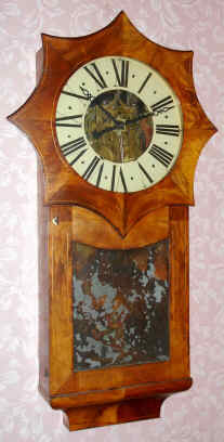 C.1850, German, I. B. Saier, Saig [Baden-Wurtemburg], an interesting 2-weight wall clock, showing a lot of American influence, the 8-sided star shaped top similar to what Silas B Terry designed for his iron case, this one of mahogany veneer over pine. — Antique Clocks Price Guide