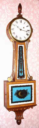 C.1965, English, Biddle and Mumford, a banjo clock made with imported glasses, dial and pendulum (from the US) and a quality weight movement. — Antique Clocks Price Guide