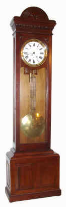 C.1880, American, Walnut Jeweler's regulator, in an unusual case with a carving of the waking sun god on top, 8-day, pinwheel movement [Swiss origin movementt]. — Antique Clocks Price Guide
