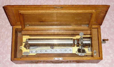 C.1895, Swiss, Mermod Freres, 12-Tune Music box in an oak case, 13" cylinder, and with Jacot's Safety Check, Fast/Slow lever, and Mermod tune indicator with repeat and change switch, key wound from right side. Tunes include turn of century favorites: Washington Post March, Now that the Day is Over, and Bicycle Built for Two. — Antique Clocks Price Guide