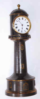 C.1890, French, LIGHTHOUSE form, brass cased timepiece, with a platform cylinder movement and porcelain dial, fixed position. — Antique Clocks Price Guide