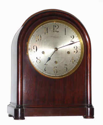 C.1900, Winterhalder and Hofmeier, 8-day 3-tr, Westminster chime mantel clock retailed by Bailey, Banks and Biddle Co., Philadelphia, in a round Gothic mahogany case, with silvered dial. — Antique Clocks Price Guide