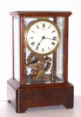 C.1910, Eureka Clock Co., Ltd, London, Battery timepiece with large seconds beating balance, supported in ball bearings, in an oak case with 5 panes of beveled glass, movement serial No. 8632. — Antique Clocks Price Guide