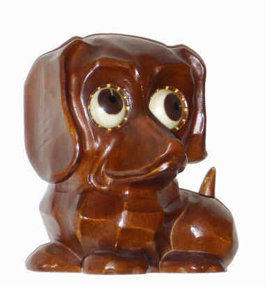 C.1955, German, Oswald, Rotating Eye clock, in the form of a Daschund, molded composition case. Tells time by the position of the pupil; time in foto is 12 minutes past 12. — Antique Clocks Price Guide