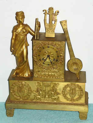 C.1820, French, Bechot, Ormolu Figural clock, MUSIC, classic gowned lady to the left supporting a pair of flutes, lyre in the center and a mandolin to the right. See very similar model, less flutes in French Bronze Clocks, by Niehuser, pg 231, fig 724. — Antique Clocks Price Guide
