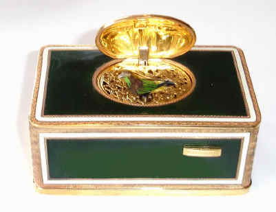 Late 20th Century, German/Swiss, singing bird box in a dark green enameled case, with engraved and gilded corners and edging. — Antique Clocks Price Guide